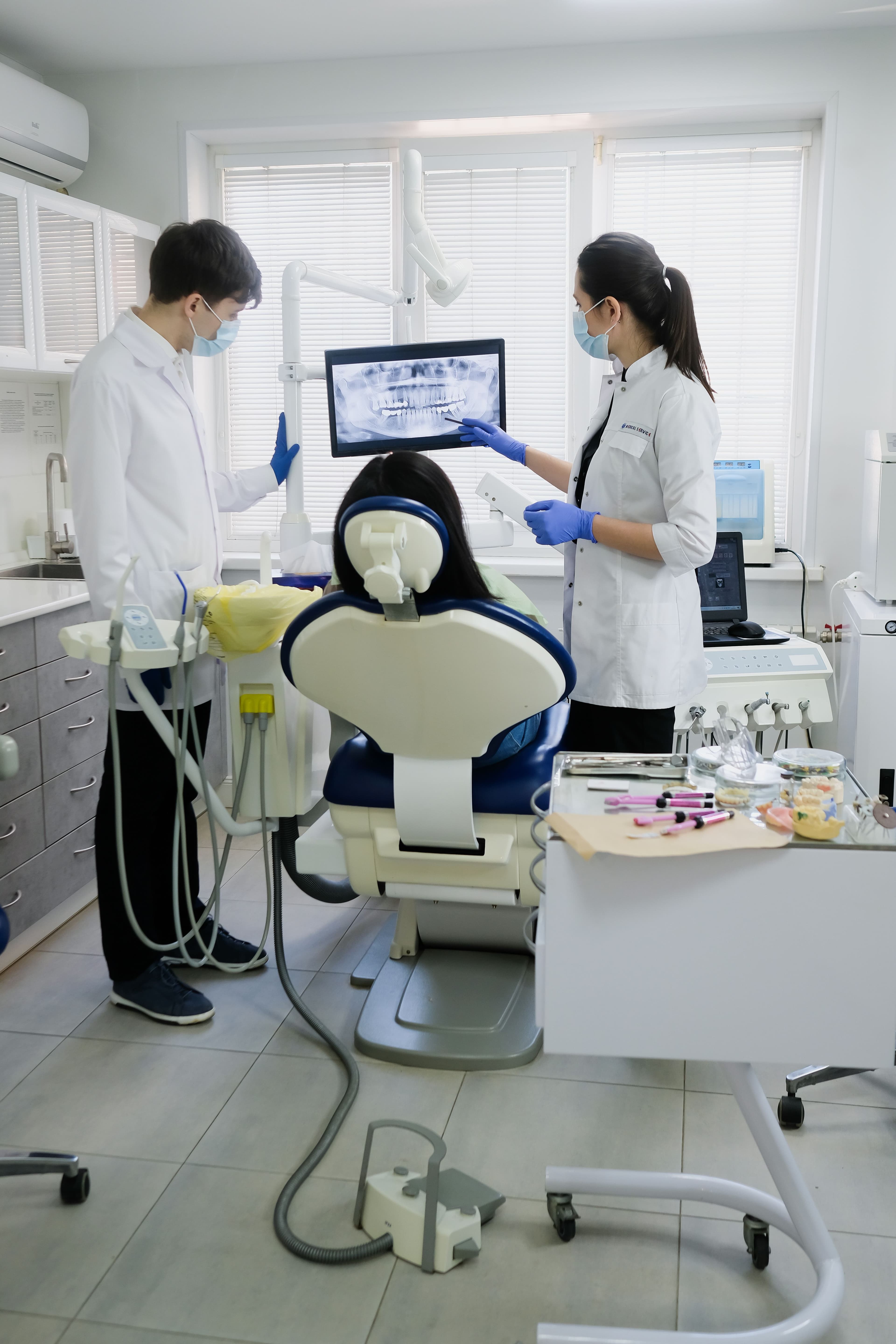 Dentist consulting with patient in a bright modern clinic